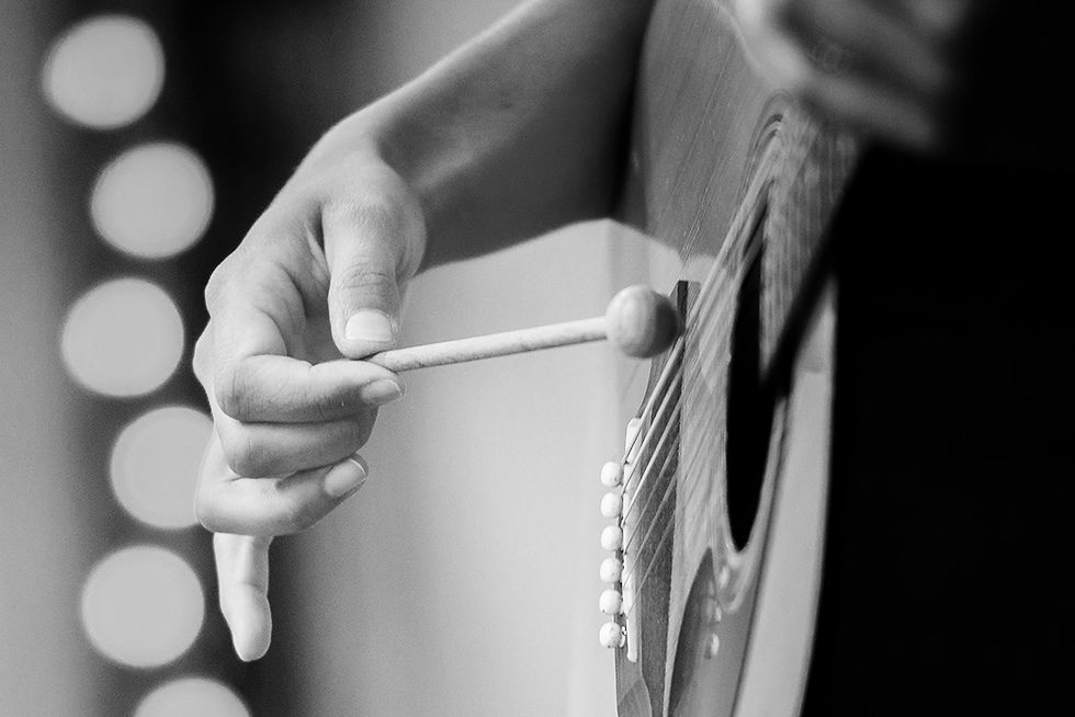acoustic guitar female hand mallet black and white