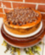 Peanut Butter Cup naked cake with caramel drizzle and crushed peanut butter cups on top