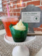 Pink lemonade drink with vanilla cupcake and business card