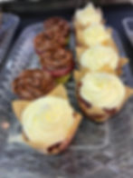 Chocolate and vanilla cupcakes lined up on a serving tray