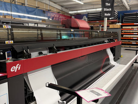 wide format printer producing large format graphics and signage inside a commercial print facility
