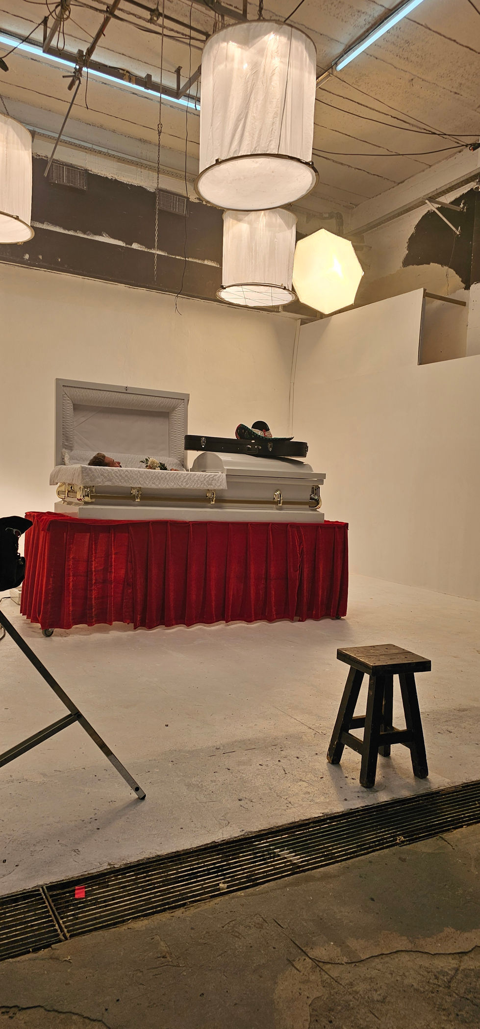 Deleted Scene Still: Artistic direction and prop arrangement featuring a casket and guitar for a poetic visual narrative.