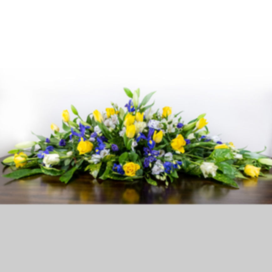 White and yellow casket spray
