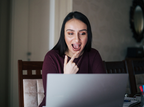 A woman on a laptop doing speech therapy.