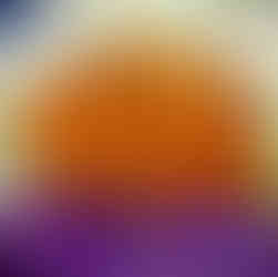 Shredded green cabbage, purple cabbage, and carrots in a metal bowl with peppercorns on top