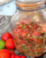 tomatoes and a big jar with a salsa