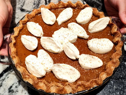 Healthy pumpkin pie with fermented crust and maple-sweetened filling topped with probiotic cream.