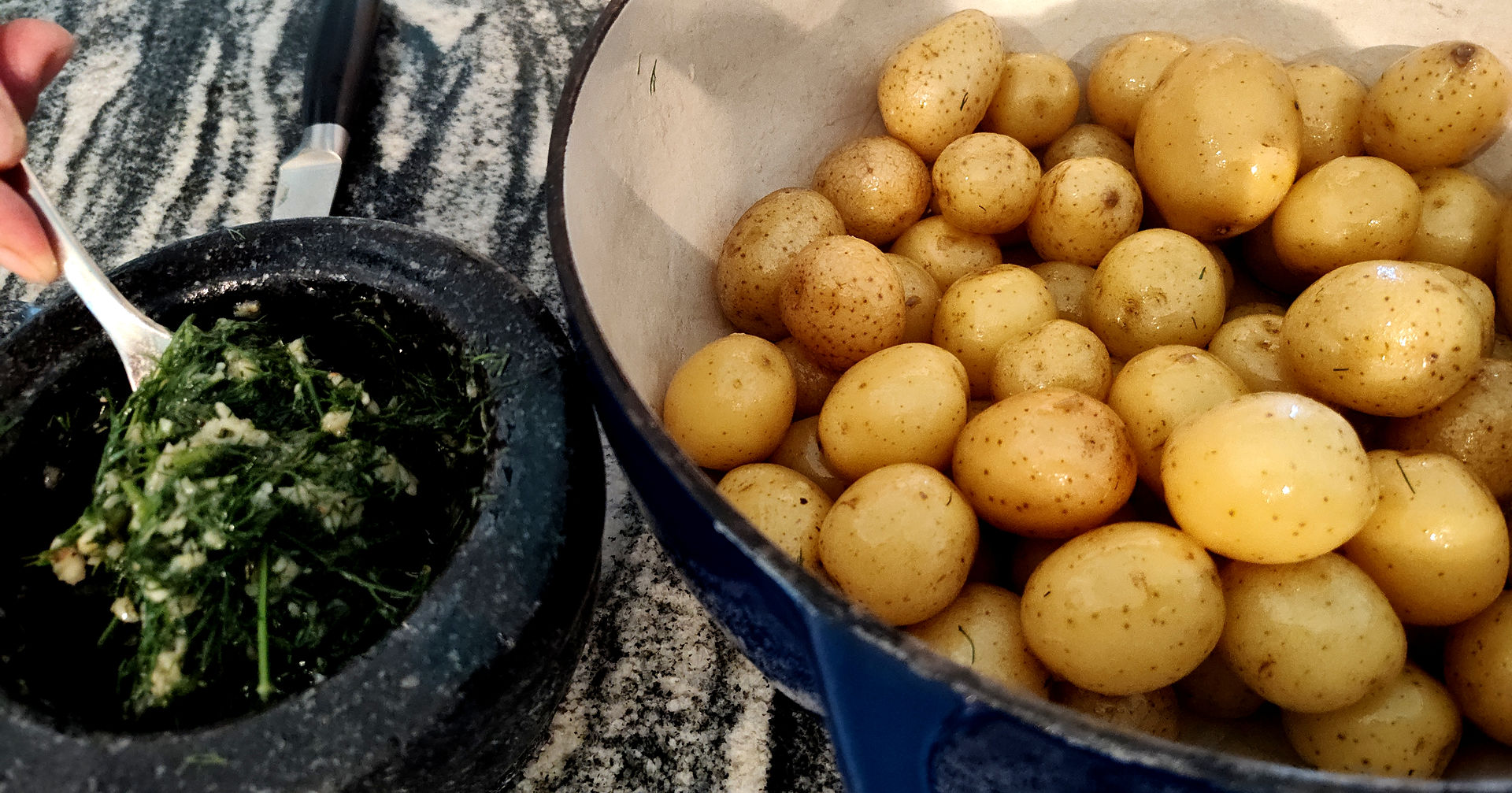 pot of cooked potatoes and garlic and dill paste next to the pot with potatoes