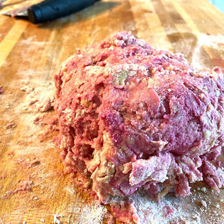 pink pasta dough on a wooden board