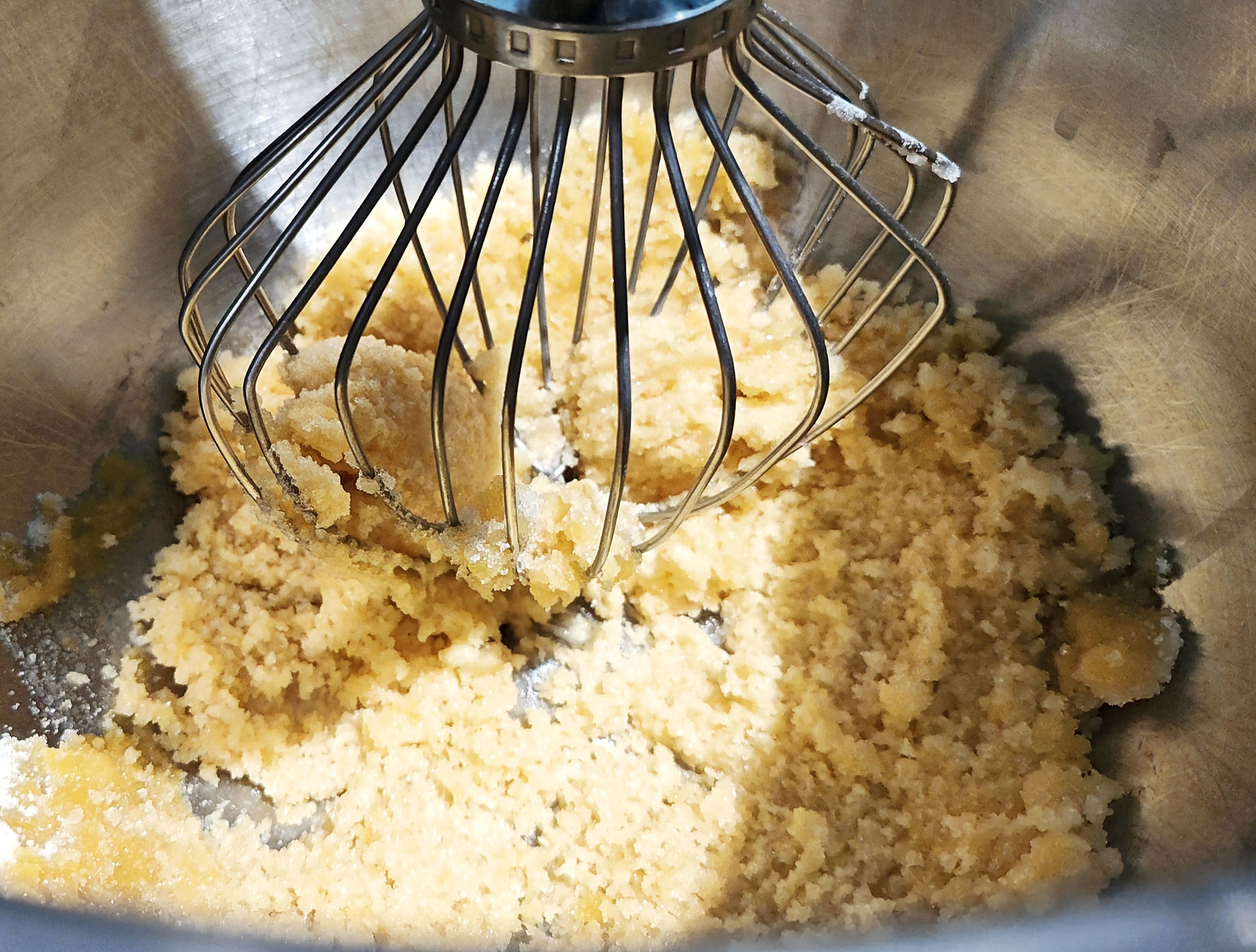 whisk in a bowl with sugar and egg yolks