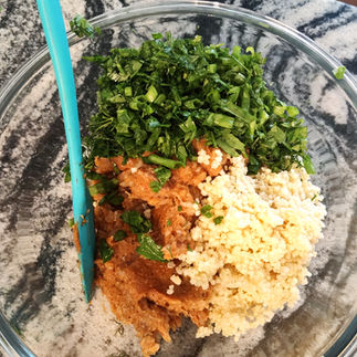 in a bowl: chopped herbs, cooked millet and shrimp paste