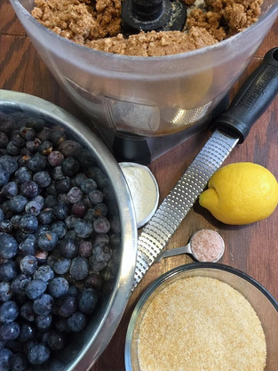 Ingredients to make blueberry cobbler: blueberries, lemon, sugar, salt, flour, and dough for crust