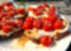 two open face tomato sandwiches