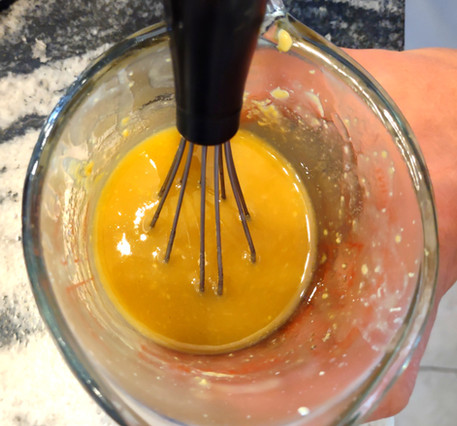 whisking the glaze in a cup