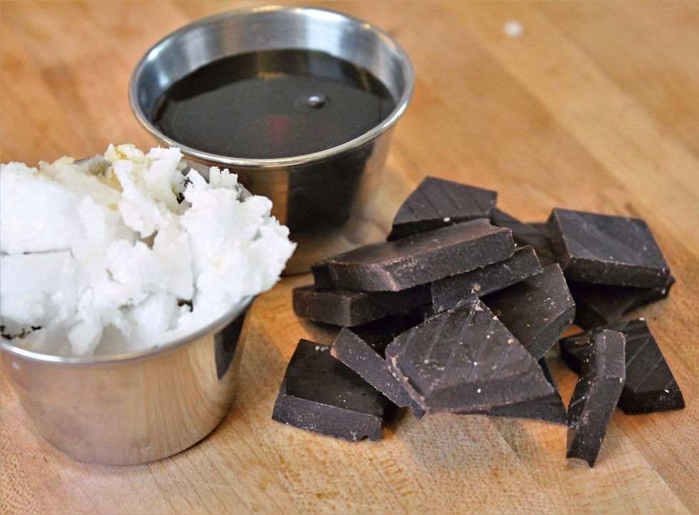 maple syrup in metal cup, chunks of dark chocolate and coconut oil in metal cup