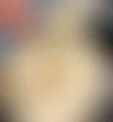 adding cheese into a pan with white sauce