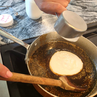 adding yogurt to the pan with molasses mixture