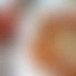 dumplings on a plate with dipping sauce and jar of kimchi