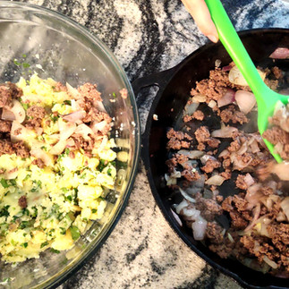 bowl with potatoes cooked and cast iron pan with meat cooked