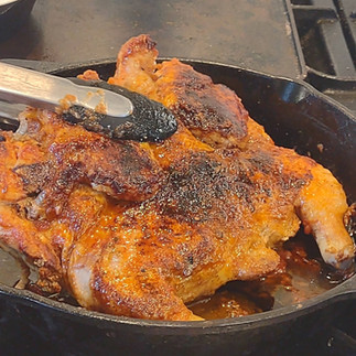 with a tong holding chicken