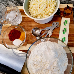 Ingredients to make goldfish crackers: flour, butter, salt, turmeric, paprika, ice water, and cheese