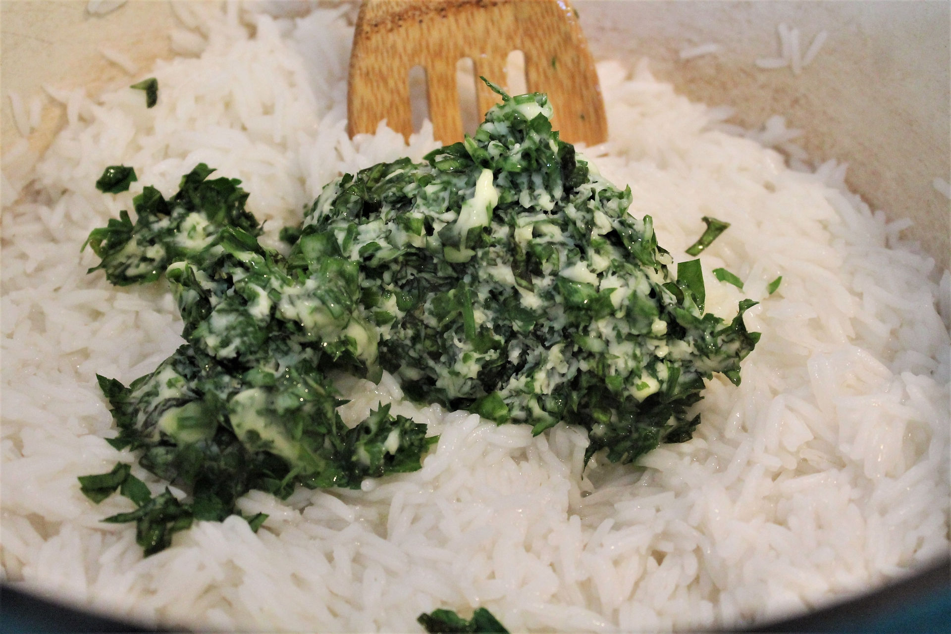 herb butter mixture in a pot with hot white rice