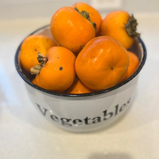 persimmon fruit in a white bowl