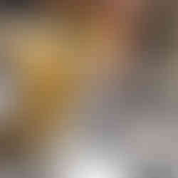 zesting lemon above the an electric mixer bowl with a cheese filling