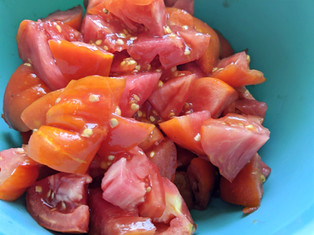 Chopped tomatoes straining in a colander