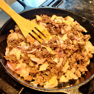 iron pan with cooked meat and onion