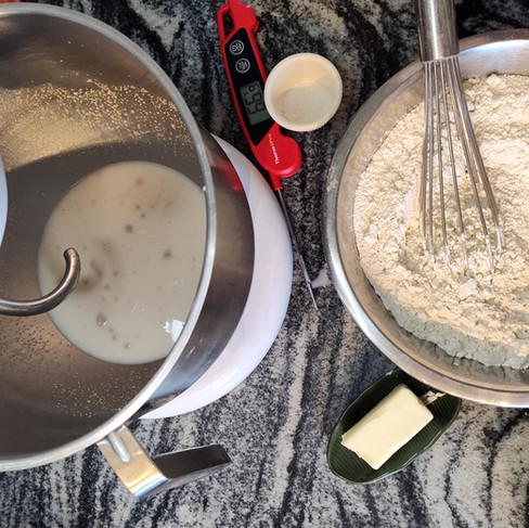 bowl with dry ingredients and electric bowl with a hook attachment with wet ingredients