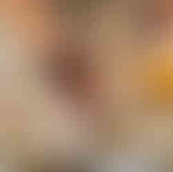 brushing pastry with a egg wash on a baking sheet