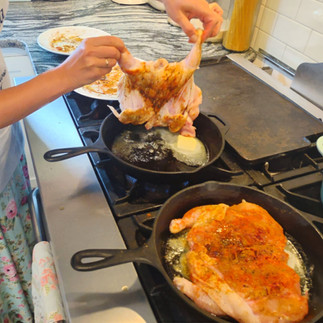 laying chicken on preheated cast iron