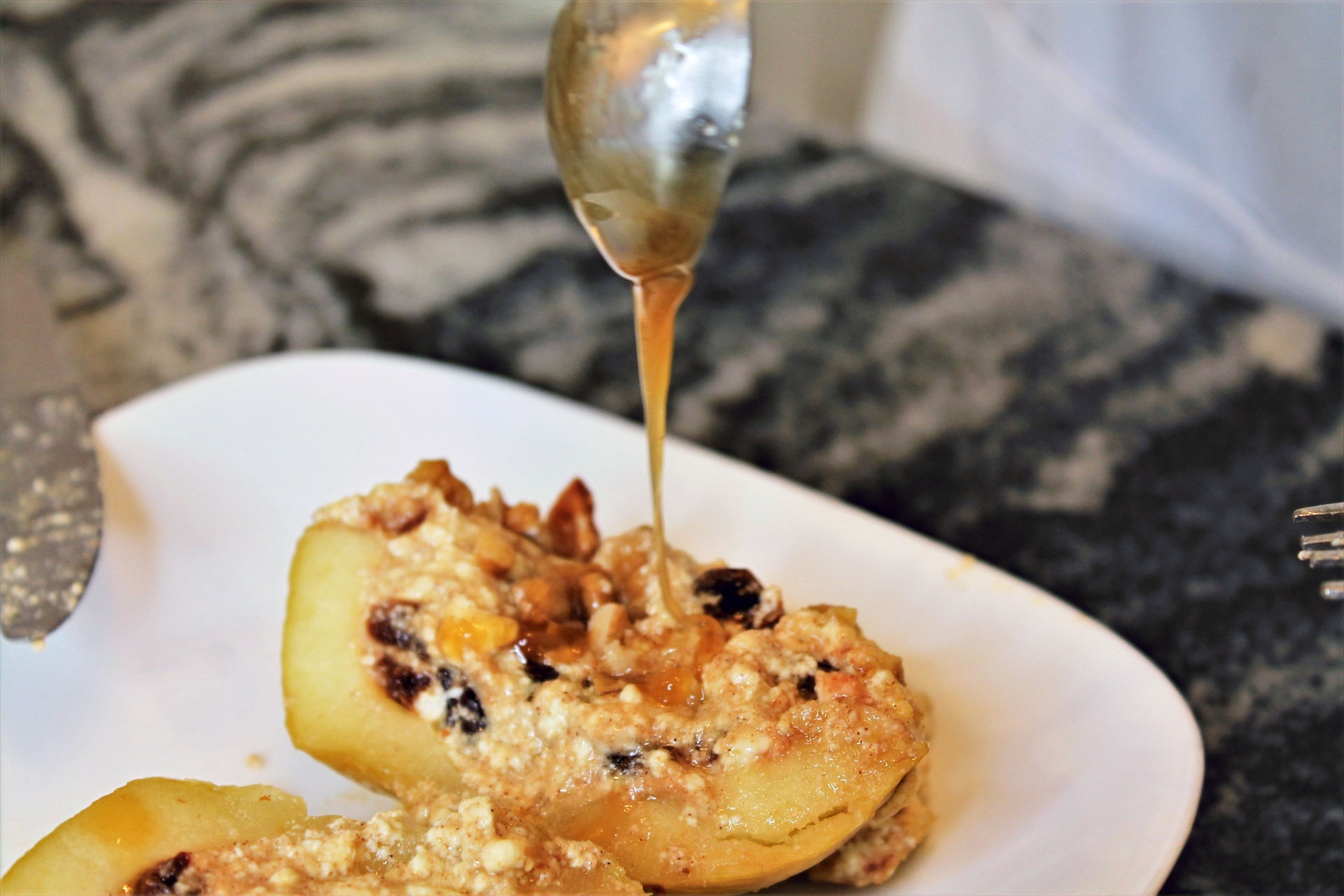 drizzling honey over baked stuffed apples