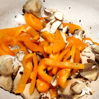 peppers, mushrooms in a pan