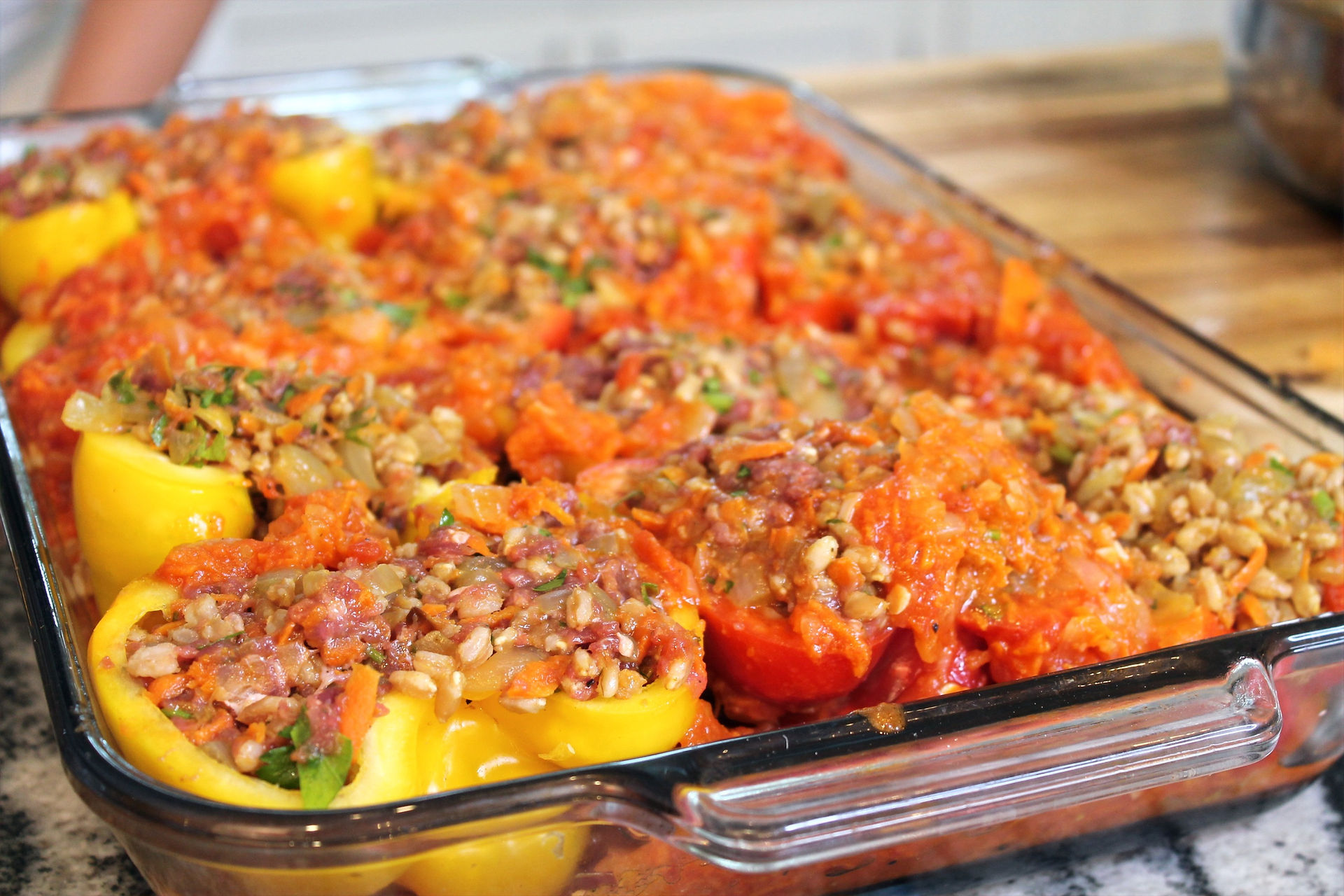 ready for the oven stuffed peppers with red sauce on top