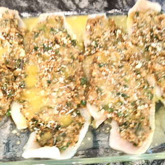 shrip stuffed flounder with lemon - butter sauce before the oven