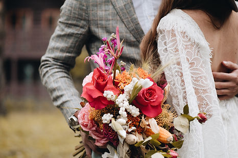 couple holds wedding flowers