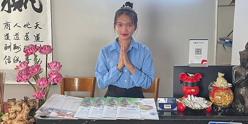 Woman making welcoming gesture at decorated table