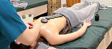 Therapist giving a hot stone massage in Cholsa Spa Phnom Penh
