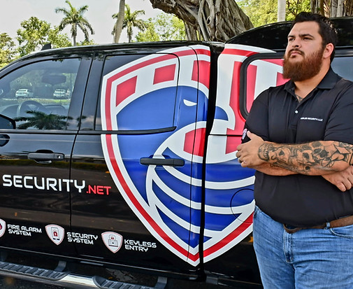 The president of naples seecurity, Josh Elizondo with his black Silverado with Naples security logo on side