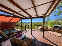 Private veranda overlook view with comfortable seating, braai, and hot tub.jpg