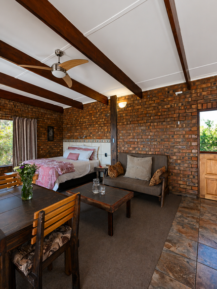 Self-catering stone accommodation in Limpopo, spacious bedroom with beautiful views. Full bathroom and kitchen