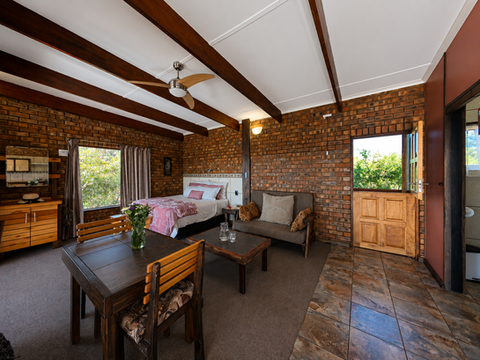 Self-catering stone accommodation in Limpopo, spacious bedroom with beautiful views. Full bathroom and kitchen