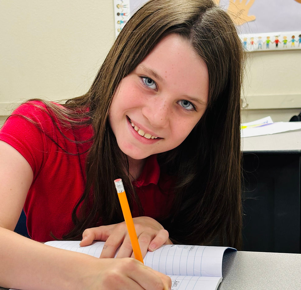 Young student practicing handwriting at home with a pencil and lined pape