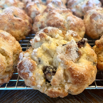 Embark on a tantalizing journey of citrusy delight with our homemade orange cranberry scone. Freshly baked to golden perfection, these scones exude a warm, inviting aroma that promises a burst of flavor with every bite. Tangy cranberries provide a delightful contrast to the bright, zesty notes of fresh orange zest, creating a harmonious symphony of taste sensations. Each tender, flaky crumb is adorned with plump cranberries, ensuring a juicy burst of sweetness in every mouthful. Whether enjoyed alongside a cup of tea or as a midday treat, these scones offer a perfect balance of tartness and citrusy freshness that is simply irresistible. Embrace the joy of homemade baking with this exquisite orange cranberry delight.