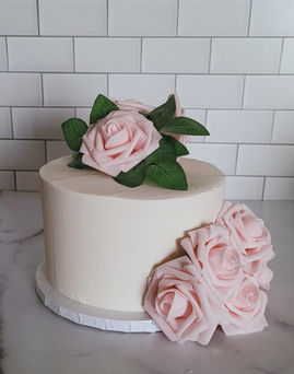 White cake with fake pink flowers baby shower cake anniversary cake birthday cake chicago cake oak park cake