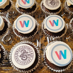 Chocolate cupcakes with Vanilla buttercream with custom toppers for Salesforce's 25th Anniversary and toppers showcasing Salesforce Women's Network logo