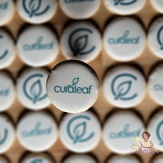 Custom cookies with 2 versions of the Curaleaf logo printed on front.