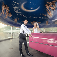 Couple posing by the pink Cadillac at the Little White Wedding Chapel in Las Vegas — classic and romantic wedding moment.